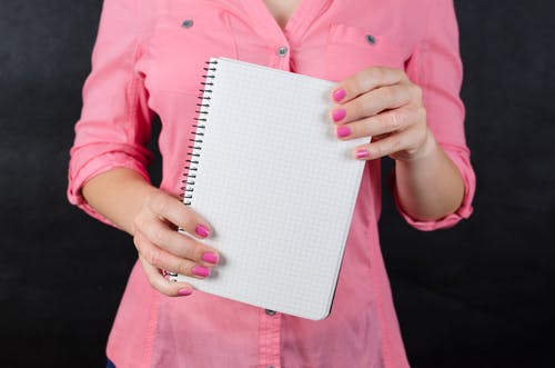 Woman holding a notepad