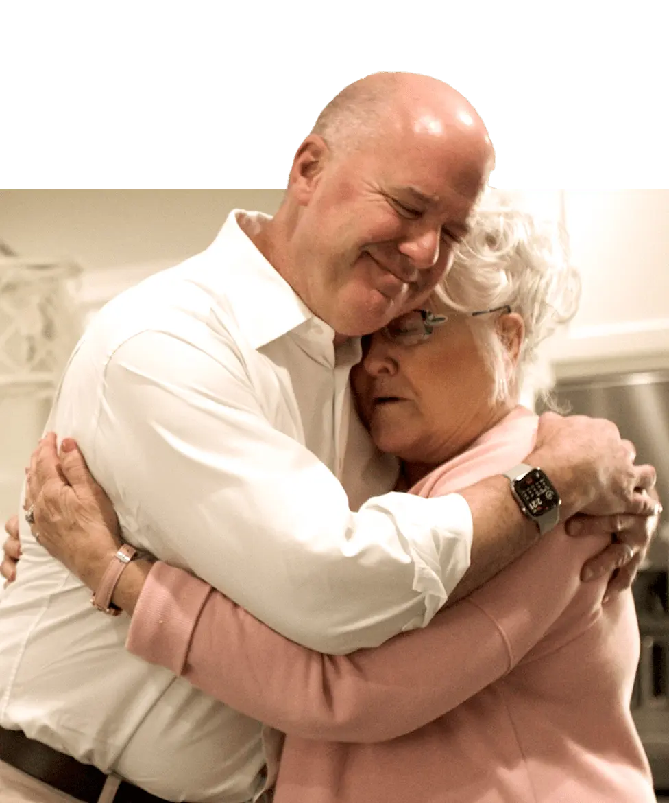 Jeff Gaughan of Baggett McCall hugging a client in her home in Lake Charles Louisiana after he helped her with her case.