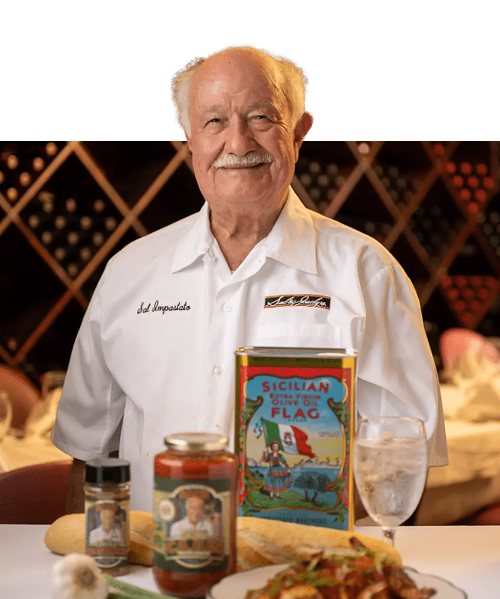 Sal Impastato in Sal and Judy's Restaurant in Lacombe Louisiana surrounded by some of his products