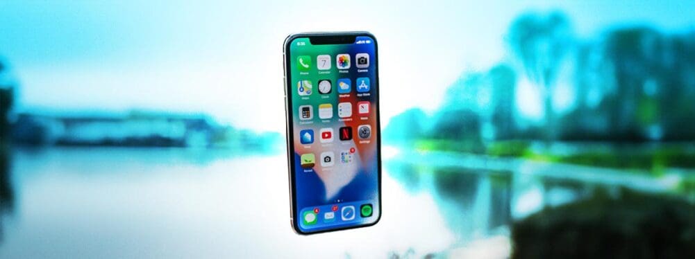 Floating iPhone in front of blurry image of a park