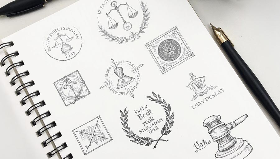 Velocity Agency graphic designers working in their sketch book on sever logo design concepts