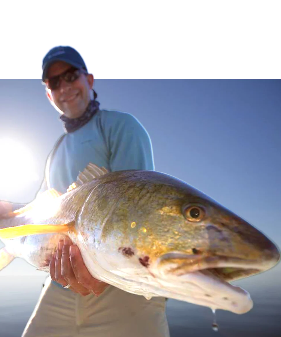 Salt water Fly Fishing Charter Fisherman after he caught a massive Red Fish in Louisiana