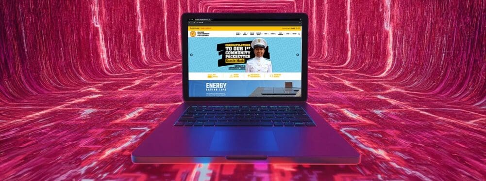 A laptop siting in a digital landscaape with an example of website design on the screen. Gricua.net is on the display.